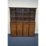 AN EARLY TO MID 20TH CENTURY OAK BOOKCASE, with a fixed cornice, four lead glazed doors enclosing