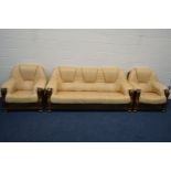 A MUSTARD LEATHER AND OAK FRAMED THREE PIECE LOUNGE SUITE, comprising a three seater settee and a