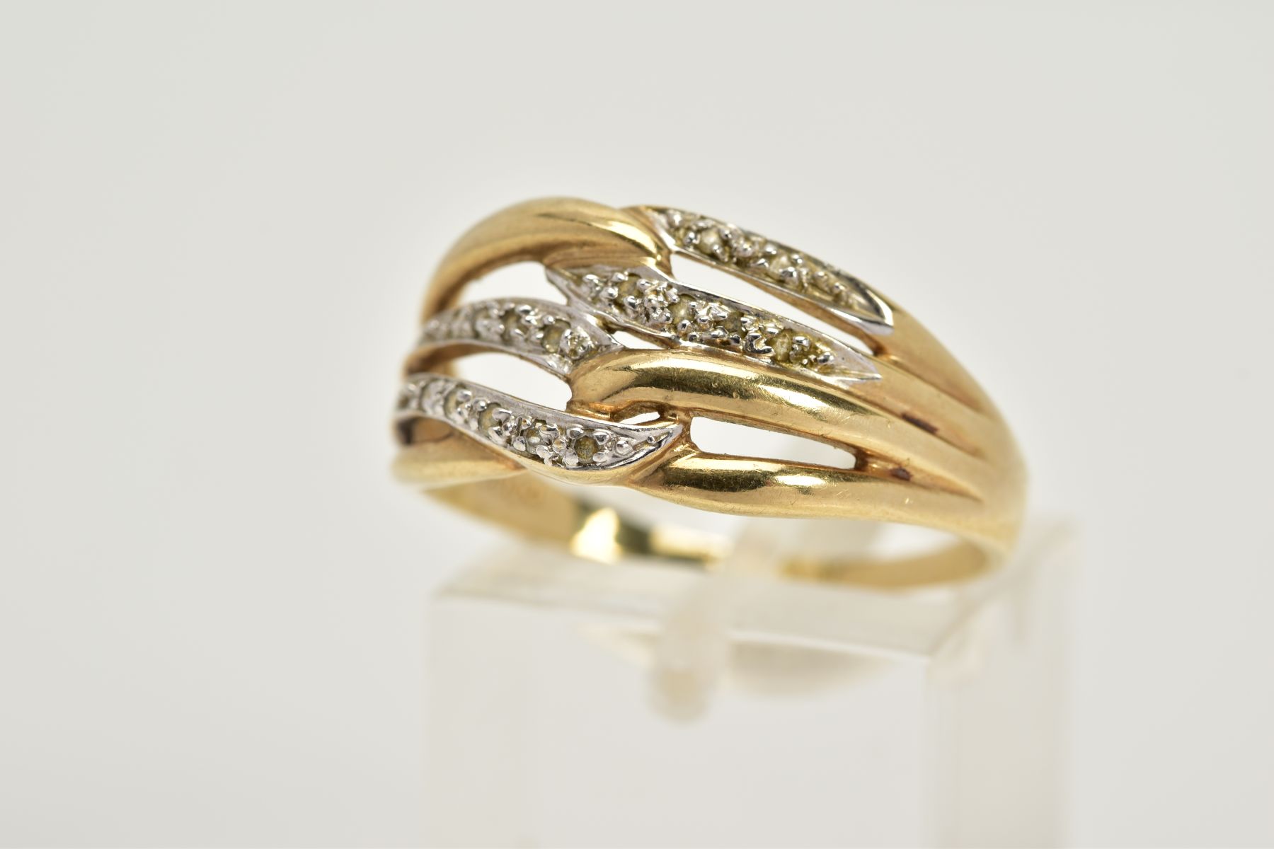 A 9CT GOLD DIAMOND OPENWORK RING, designed with four interlocking openwork hoops, two hoops set with