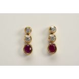 A PAIR OF 9CT GOLD DIAMOND AND RUBY DROP EARRINGS, each designed with two round brilliant cut