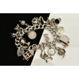 A SILVER CHARM BRACELET, suspending nineteen charms, such as a lamp, winners cup, book, teapot,