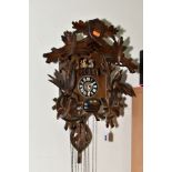 A MID TWENTIETH CENTURY BLACK FOREST STYLE CUCKOO CLOCK, with matched pediment and pendulum, with