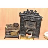 A VICTORIAN CAST IRON MINIATURE FIREPLACE WITH INTEGRAL FIRE BASKET, height 25cm, together with a