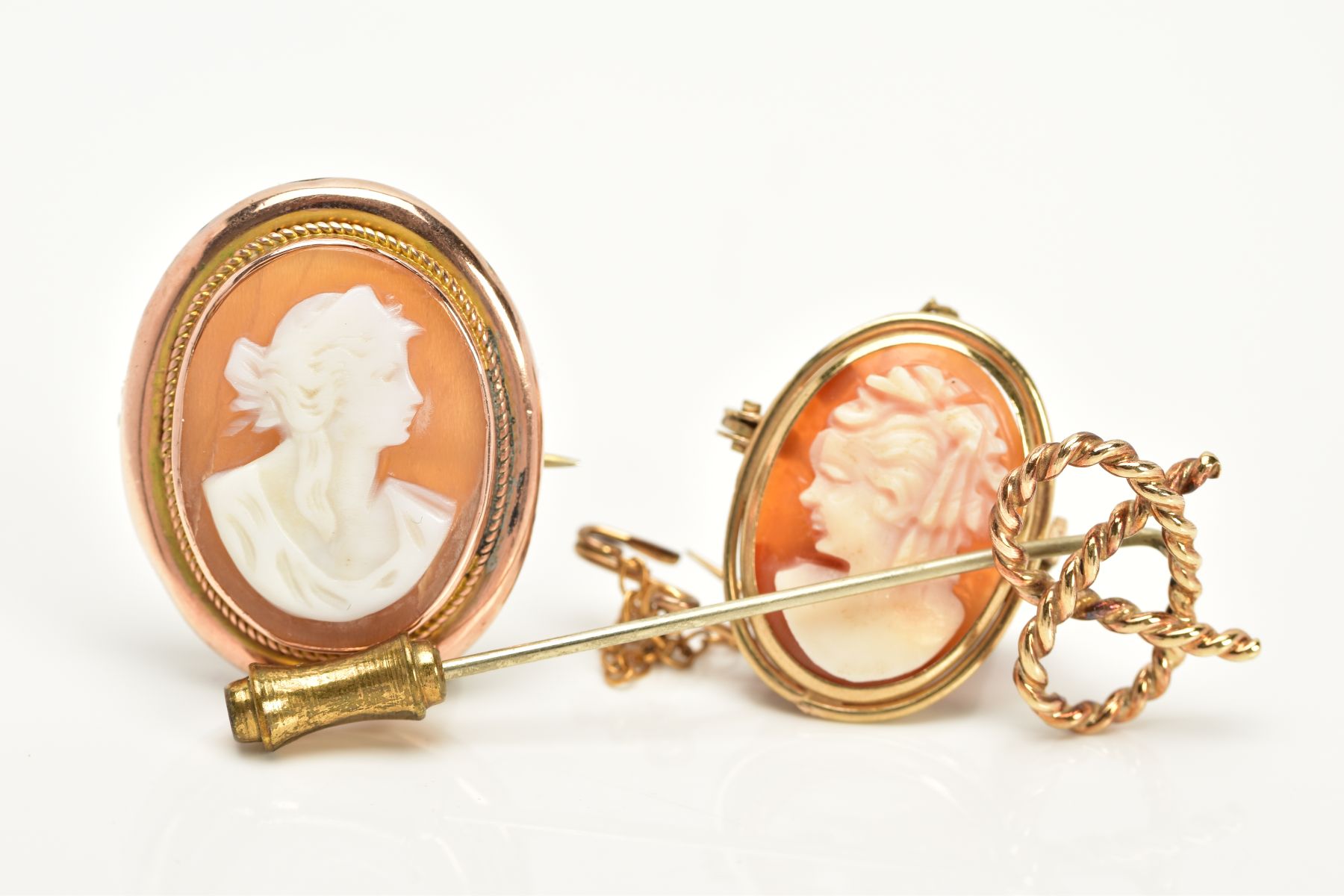 THREE BROOCHES to include two gold cameo brooches depicting maidens in profile, one hallmarked