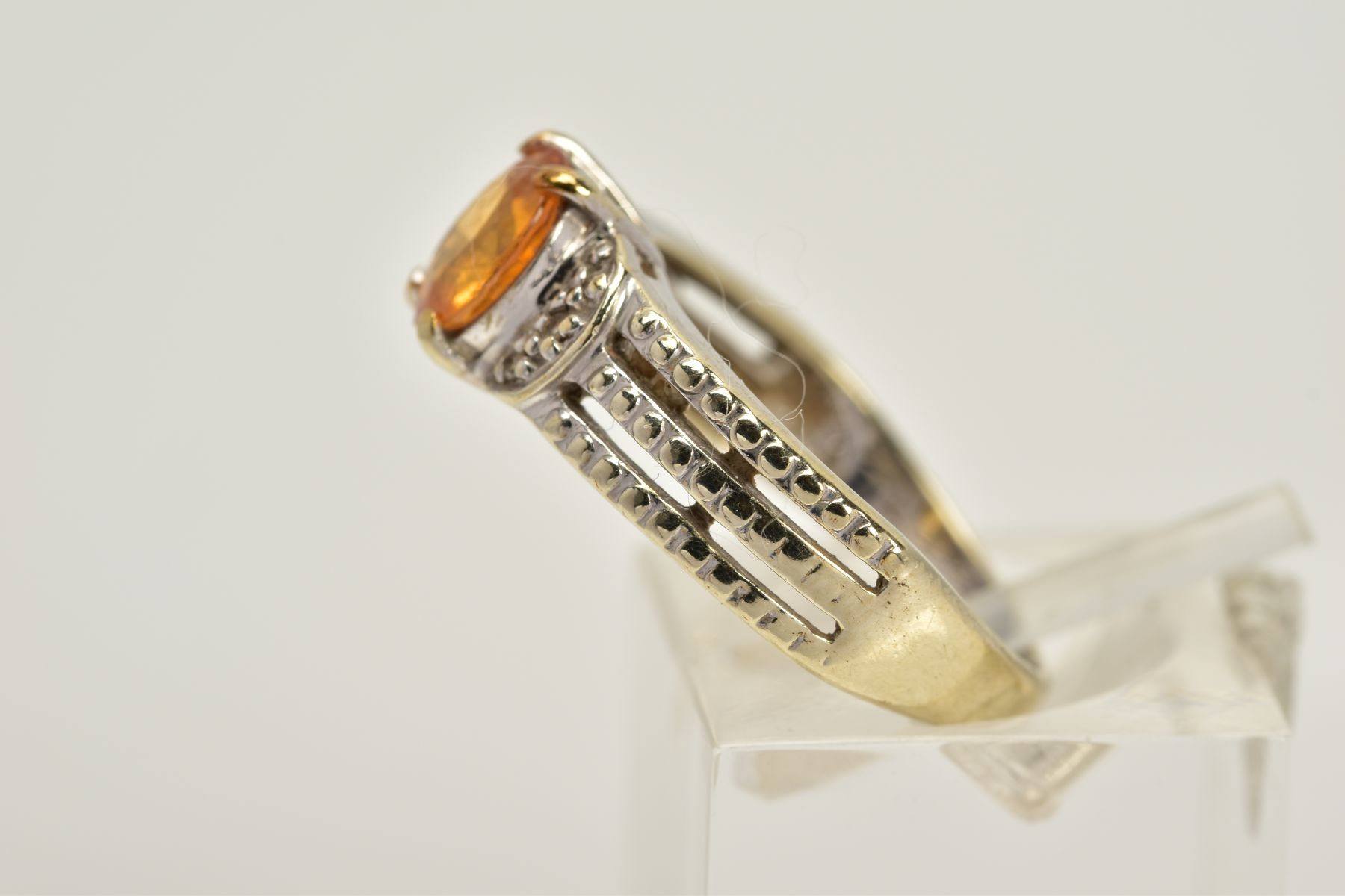 A 9CT WHITE GOLD YELLOW SAPPHIRE RING, designed with a claw set, oval cut yellow sapphire, flanked - Image 2 of 3