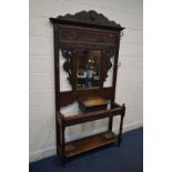 AN EARLY TO MID TWENTIETH CENTURY OAK HALL STAND, with six shaped metal hooks, distressed mirror,