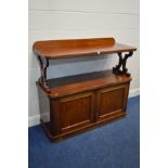 A VICTORIAN MAHOGANY BUFFET supported by shaped supports over a two door cupboard enclosing two
