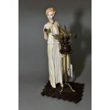 AN ALBANY BONE CHINA AND BRONZE FIGURE, 'Monaco', height 19.5cm (missing petals from item in her