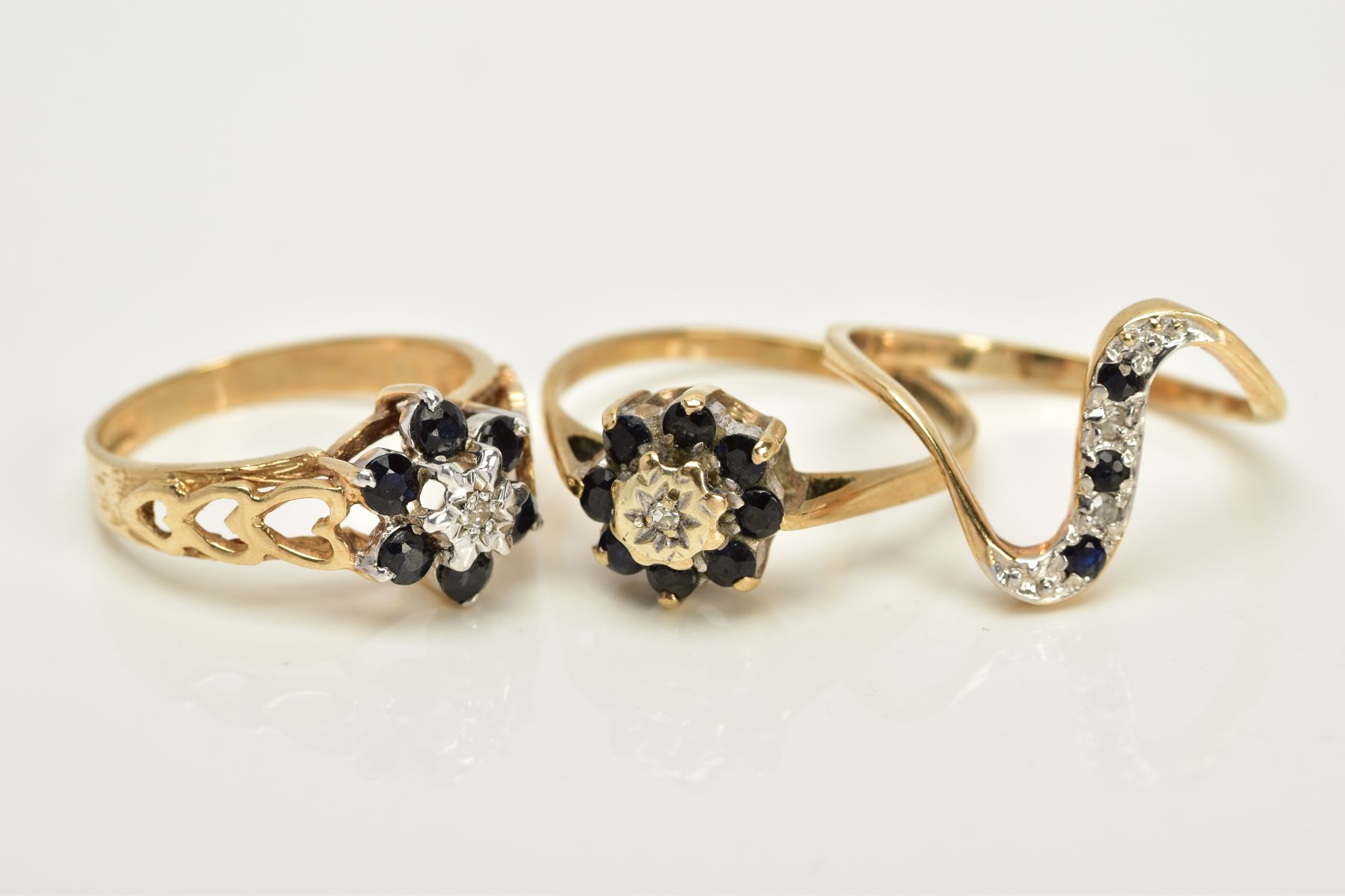 THREE 9CT GOLD SAPPHIRE AND DIAMOND RINGS, to include two clusters, each designed with a single - Image 2 of 3