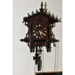 AN EARLY TWENTIETH CENTURY BLACK FOREST STYLE CUCKOO CLOCK, pierced pediment and sides, wooden