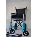 A CARE CO MODERN WHEELCHAIR in metallic turquoise finish with two foot rests and padded seat pad