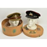 A HAT BOX CONTAINING TWO MILITARY OFFICERS CAPS, a WWI era drab Olive colour peaked cap, silver