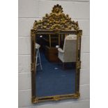 A MODERN FOLIATE GILT FRAMED WALL MIRROR, 67cm x 127cm