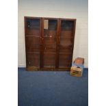 A LARGE DISTRESSED VICTORIAN MAHOGANY TRIPLE DOOR ASTRAGAL GLAZED BOOKCASE, with fourteen adjustable