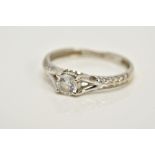 AN 18CT WHITE GOLD GEM SET RING, designed with a central circular cut cubic zirconia, bifurcated