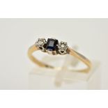 A YELLOW METAL SAPPHIRE AND DIAMOND RING, designed with a central rectangular cut sapphire,