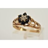 A 9CT GOLD SAPPHIRE AND DIAMOND CLUSTER RING, designed with a star set single cut diamond centre,