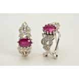 A MODERN PAIR OF FANCY RUBY AND DIAMOND STUD EARRINGS, fitting to an Omega post fitting, estimated