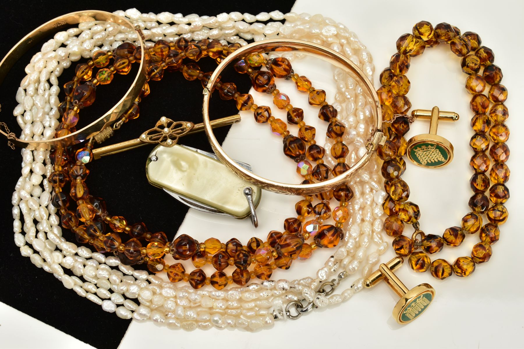 A MISCELLANEOUS COLLECTION OF JEWELLERY ITEMS to include two rolled gold bangles, a gold plated pair