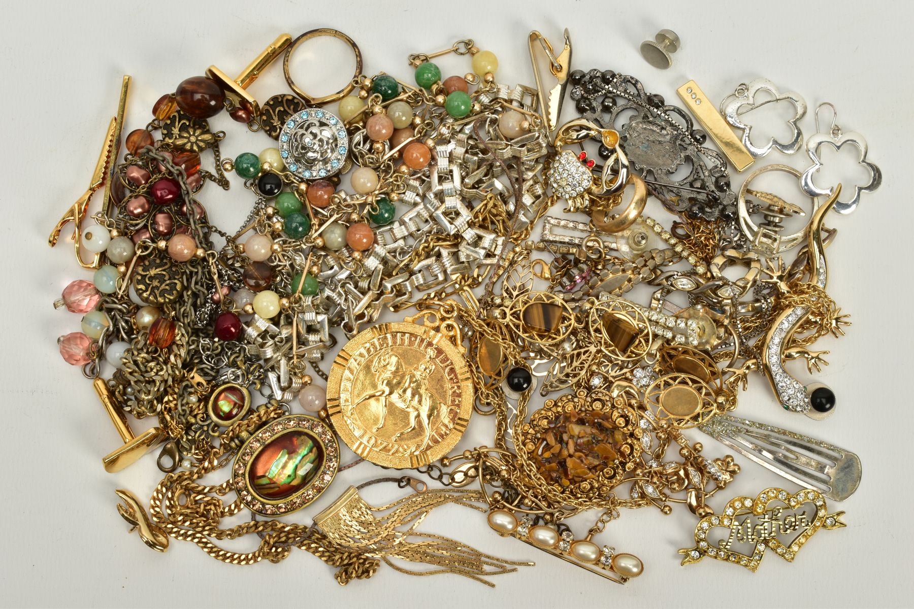 A SELECTION OF COSTUME JEWELLERY, to include a mounted yellow metal Elizabeth II 1977