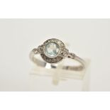 A 9CT WHITE GOLD TOPAZ AND DIAMOND HALO RING, designed with a central, circular cut blue topaz,