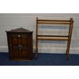A REPRODUCTION OAK PANELLED HANGING SINGLE DOOR CORNER CUPBOARD, together with a towel rail (2)