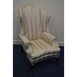 A REPRODUCTION MAHOGANY WING BACK ARMCHAIR, in the George II style, with stripped upholstery on