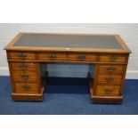 AN EDWARDIAN WALNUT PEDESTAL DESK, with a distressed brown leatherette top, with three frieze