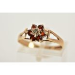 A 9CT GOLD GARNET AND DIAMOND CLUSTER RING, designed with a central single cut diamond, circular cut