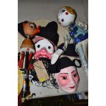 A SMALL GROUP OF WOODEN, FABRIC AND METAL PUPPETS AND MASKS, including Oriental themes, Ugly