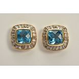 A PAIR OF TOPAZ AND DIAMOND EARRINGS, each yellow metal earring set with a cushion cut blue topaz