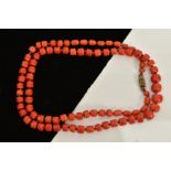 A CORAL BEAD NECKLACE, comprising of graduated unpolished coral beads, ranging from 3.8mm-7.5mm on a