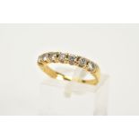 AN 18CT GOLD DIAMOND HALF ETERNITY RING, designed with seven claw set round brilliant cut
