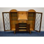 AN EARLY TO MID 20TH CENTURY OAK SIDE BY SIDE BUREAU/BOOKCASE lead glazed single doors enclosing