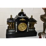 A LATE VICTORIAN BLACK PAINTED METAL MANTEL CLOCK OF ARCHITECTURAL FORM, gilt and silvered mounts,