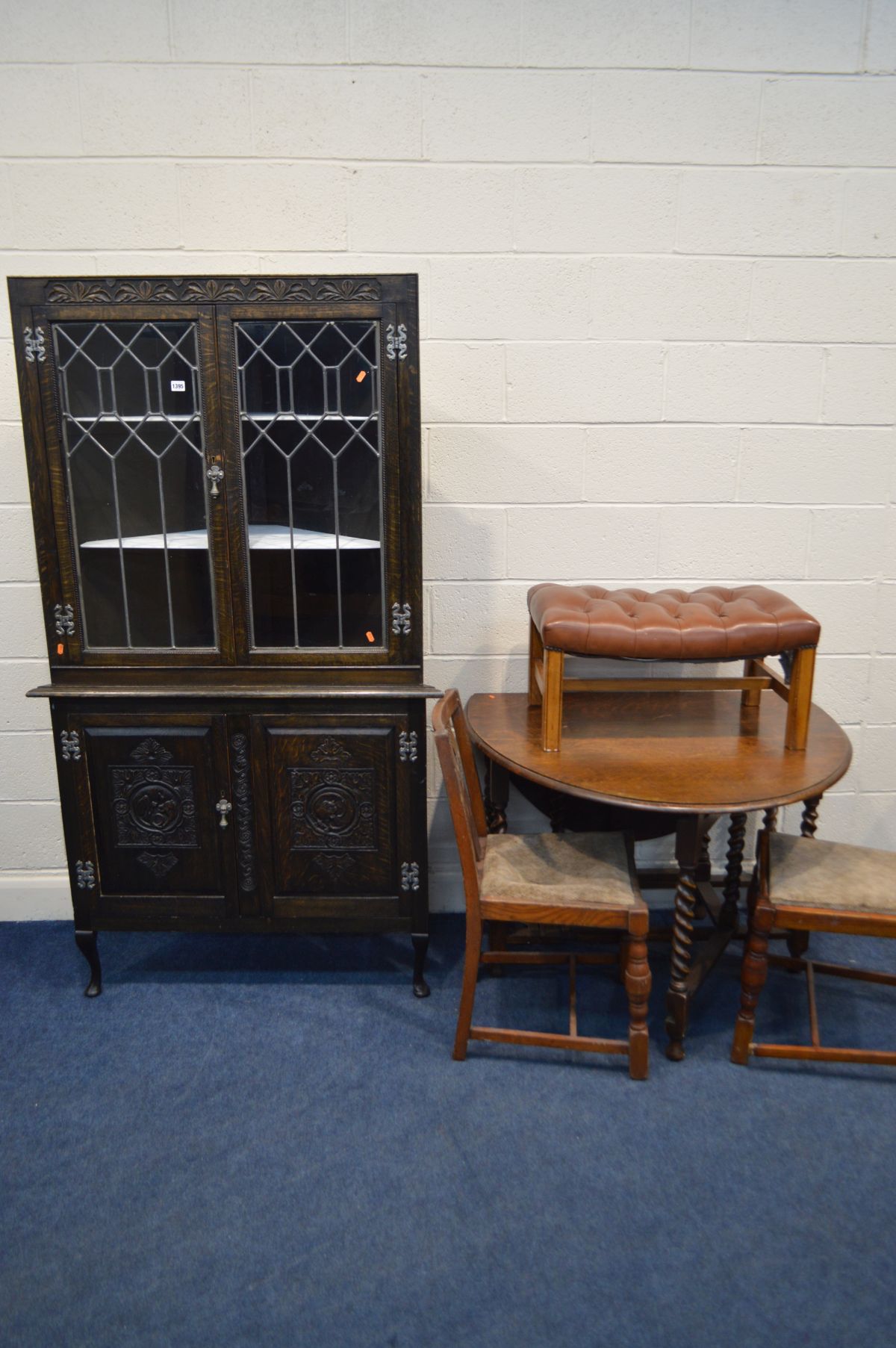 AN OAK BARLEY TWIST DROP LEAF TABLE, four chairs (sd) a brown buttoned leather footstool on an oak