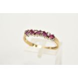 A 9CT GOLD RUBY AND DIAMOND HALF HOOP RING, designed with five marquise cut rubies, interspaced with