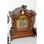 A LATE 19TH CENTURY WALNUT CASED BRACKET CLOCK, domed top with turned wooden finials, gilt metal