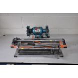 A CLARKE 6'' BENCH GRINDER (PAT pass and working), a Magnusson 60cm cut tile cutter and a