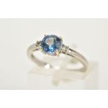 A 9CT WHITE GOLD TOPAZ RING, designed with a claw set circular cut coated topaz (mystic topaz)