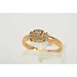 A YELLOW METAL DIAMOND RING, designed with a central panel set with nine round brilliant cut