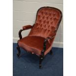 A VICTORIAN MAHOGANY SPOONBACK OPEN ARMCHAIR, covered in pink buttoned upholstery, on cabriole front