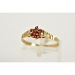 A 9CT GOLD GARNET CLUSTER RING, designed with a small central cluster set with seven circular cut