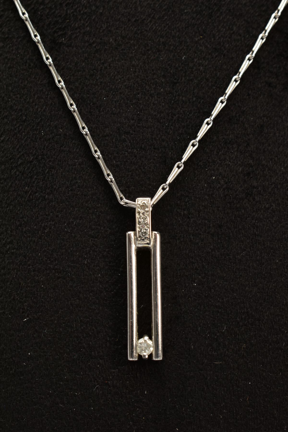 A 9CT WHITE GOLD DIAMOND PENDANT NECKLACE, the open work rectangular pendant, set with a single