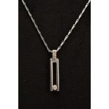 A 9CT WHITE GOLD DIAMOND PENDANT NECKLACE, the open work rectangular pendant, set with a single
