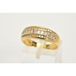 AN 18CT GOLD DIAMOND TRIPLE BAND RING, designed with a central row of channel set princess cut