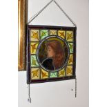 A STAINED GLASS WINDOW PANEL HAVING A FEMALE PORTRAIT titled Winter to the Centre, foliate