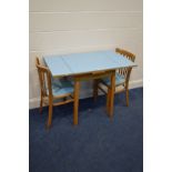 A MID 20TH CENTURY LIGHT BLUE FORMICA TOPPED EXTENDING KITCHEN TABLE, on a beech frame and a pair of