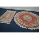 A CIRCULAR CHINESE PINK GROUND RUG, diameter 186cm, together with a similar rectangular rug (2)