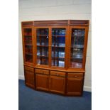 A MID TO LATE 20TH CENTURY ORIENTAL HARDWOOD GLAZED FOUR DOOR CANTED BOOKCASE, enclosing triple